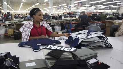 Laurette Eugene assembles a body armor vest