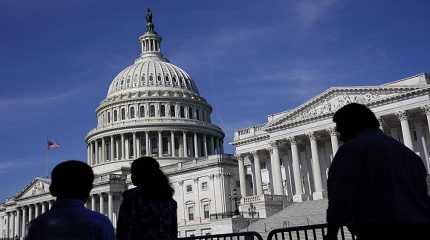 People walk outside the U.S Capitol building