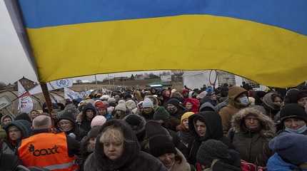 Oleksandr Osetynskyi holds a Ukrainian flag