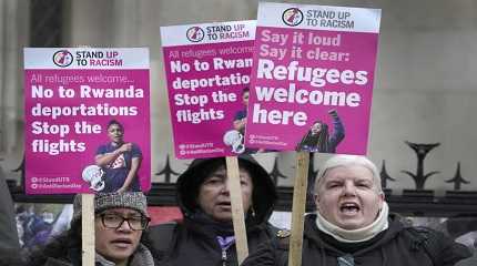 campaigners hold banners outside the High Court