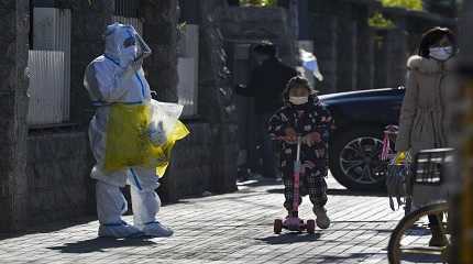 child wearing a face mask and riding on a scooter