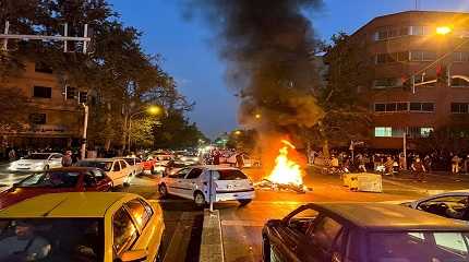 police motorcycle burns during a protest