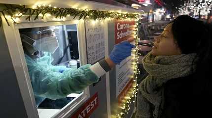 test center employee performs a coronavirus test
