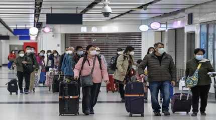 Travelers wearing face masks