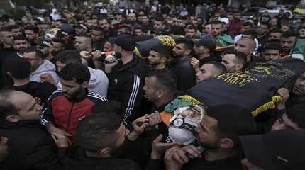 Mourners carry the bodies.