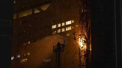 firefighter sprays water onto a fire