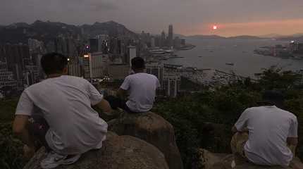 Chinese tourists look at sunset