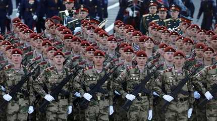 Russian service members march  for a military parade