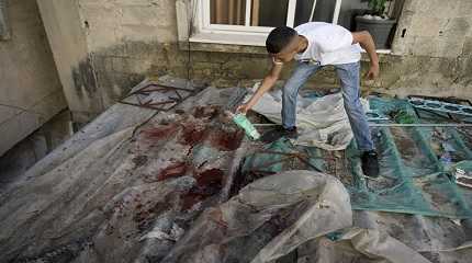 boy looks at blood stains after a military raid