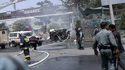 Afghan fire fighters extinguish vehicles