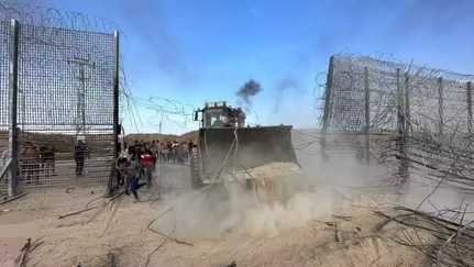 Hamas bulldozer removing Israeli fence