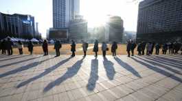 People wait for their coronavirus test