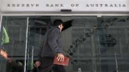 A man walks past the Reserve Bank of Australia in Sydney