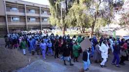 Health workers led by nurses take part in a demonstration over salaries
