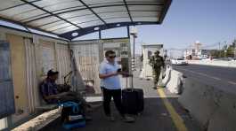 Israeli soldier patrols a bus stop