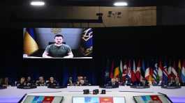 Volodymyr Zelenskyy addresses leaders via a video screen during a round table meeting at a NATO summit