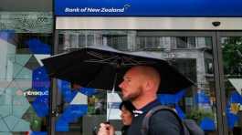 People walk past a bank in Auckland