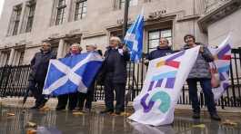Scottish flags are held by demonstrators