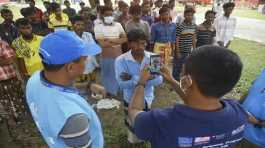 IOM and UNHCR workers take photographs