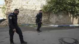 Israeli policemen walk towards the house of an Arab assailant