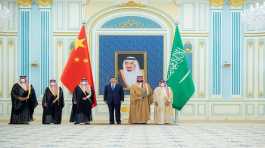 Mohammed Bin Salman stands with Xi Jinping