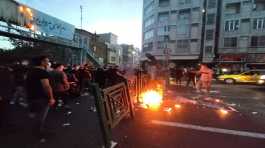 People light a fire during a protest