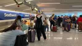 Travelers wait at a Southwest Airlines
