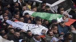 Mourners carry the bodies of Samer Houshiyehand Fouad Abed