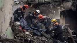 Rescue workers transfer the body