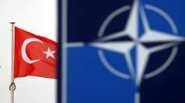 Turkish flag flies next to NATO logo