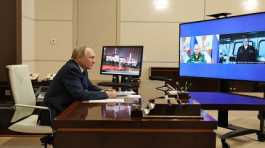 Vladimir Putin listens  the report