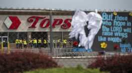 Investigators stand outside the Tops