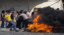 Palestinian demonstrators clash with the Israeli army