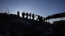 Rescue teams search for people in the rubble