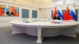 Vladimir Putin talks with Xi Jinping via a video link