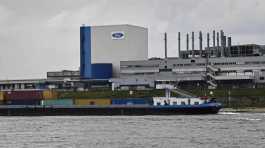 container ship passes the Ford car plant