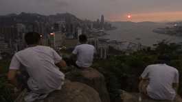 Chinese tourists look at sunset