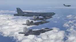 U.S. B-52 bomber, C-17, and U.S. Air Force F-22 fighter jets fly