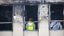 Fire and Police investigators inspect inside the Loafers Hostel in Wellington