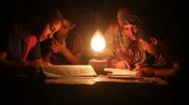 Powercut in Gaza reading with kerosin lamp