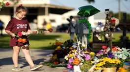 child mourns for victims of a school mass shooting in USA