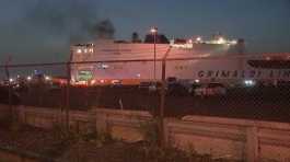 smoke rises from a cargo ship
