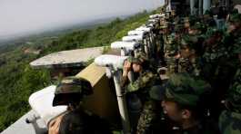 south korean soldiers look at the North Korean side