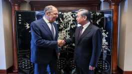 Sergei Lavrov shakes hands with Wang Yi