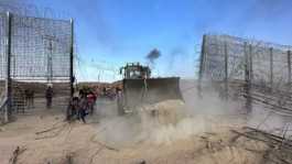 Hamas bulldozer removing Israeli fence