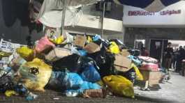 waste and trash are accumulated in front of Al-Shifa Hospital