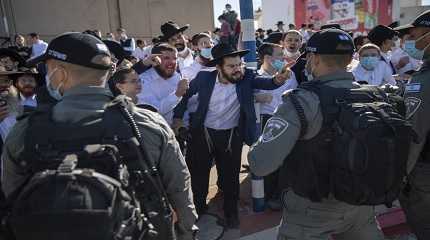 Ultra-Orthodox Jews argue with Israeli border police officers