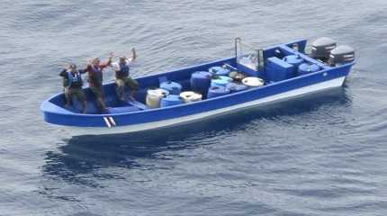 Jeffri Dávila-Reyes, and two others hold their hands in the Caribbean Sea