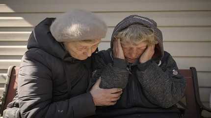 A neighbor comforts Natalia Vlasenko