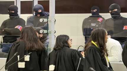 Lawyers speak with defendants through the glass